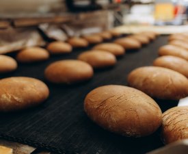 Dessert bread baking in oven. Production oven at the bakery. Baking bread. Manufacture of bread.