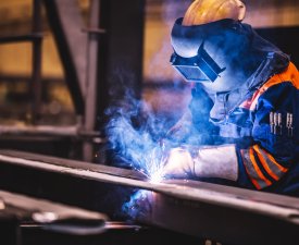 Worker welding in a factory. Heavy industry, welder work